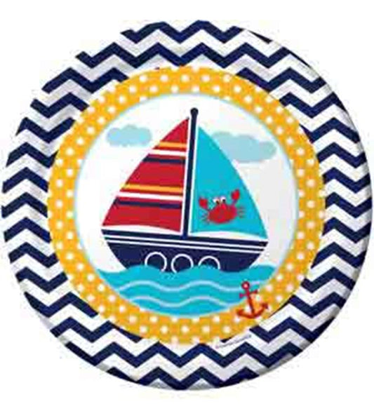 Round paper plate with navy blue chevron border, yellow polka dot ring, and sailboat with red crab on light blue water.