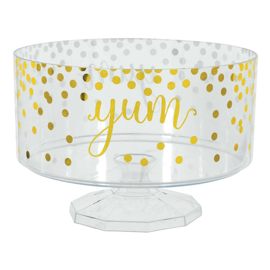 Clear plastic trifle bowl with gold polka dots and "yum" text on pedestal base.