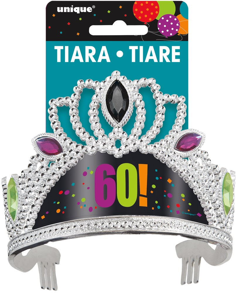 Silver plastic tiara with purple, green, and black jewel accents and "60!" in colorful letters on a black background with.