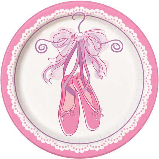 Round pink paper plate with scalloped edge and ballet shoes tied with a ribbon in the center.