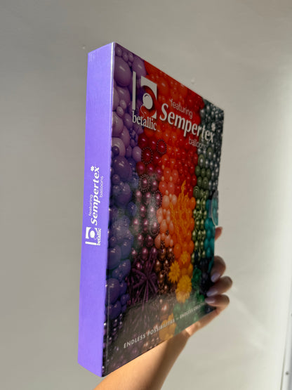 Sempertex color portfolio chart with a vibrant gradient cover showing various balloon colors in a rectangular book format.