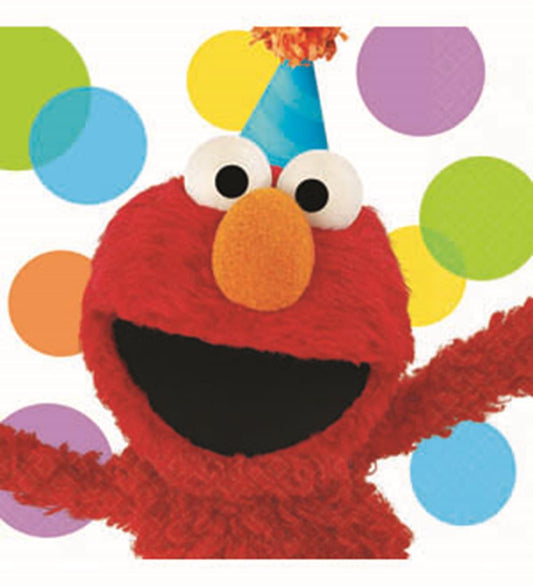 Red Elmo character napkin with wide smile, large white eyes, and orange nose against colorful confetti background.
