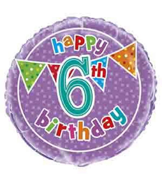 Round purple foil balloon with white polka dots, colorful "happy 6th birthday" text, and triangular party flags.