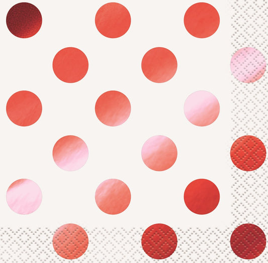White napkins with large shiny red foil polka dots and textured edges.