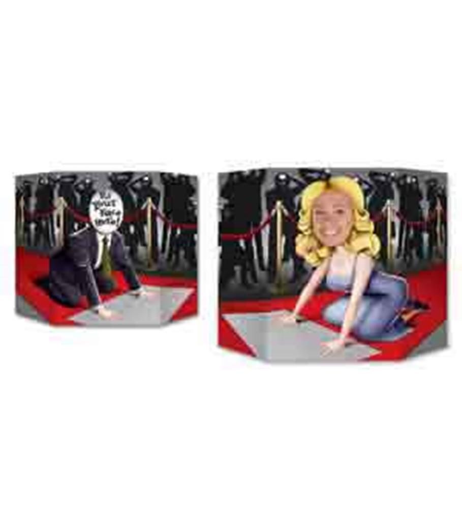 Two black photo props shaped like speech bubbles with cartoon adults on a red carpet; one person is kneeling in a tuxedo,.