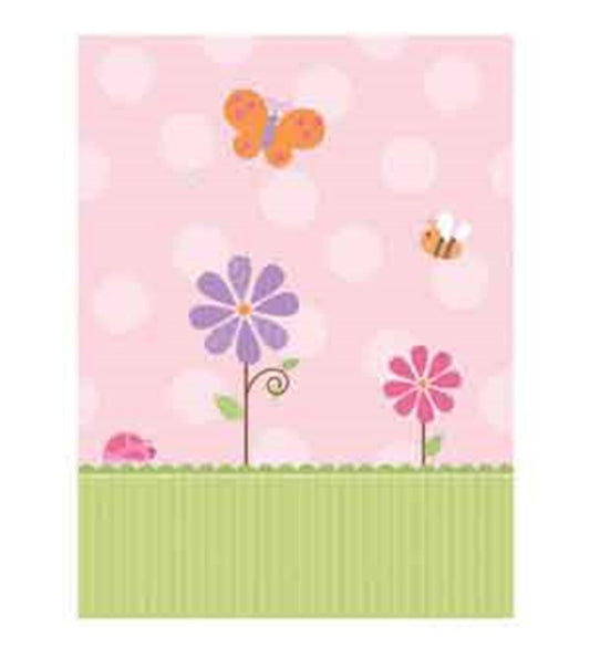 Pink baby shower tablecover with white polka dots, purple and pink flowers, orange butterfly, bee, and green striped grass.