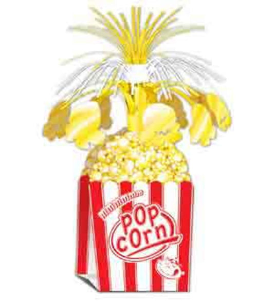 Red and white striped popcorn box centerpiece filled with popcorn, topped with gold, white, and silver starburst decorations.