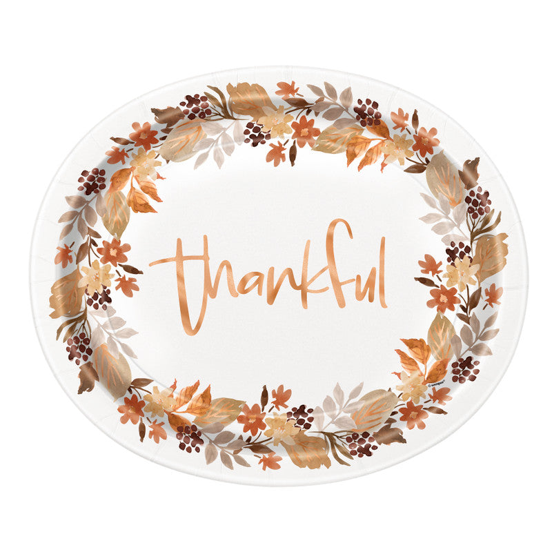 Oval white plate with autumn leaves border in brown and orange hues and "thankful" written in cursive orange letters.