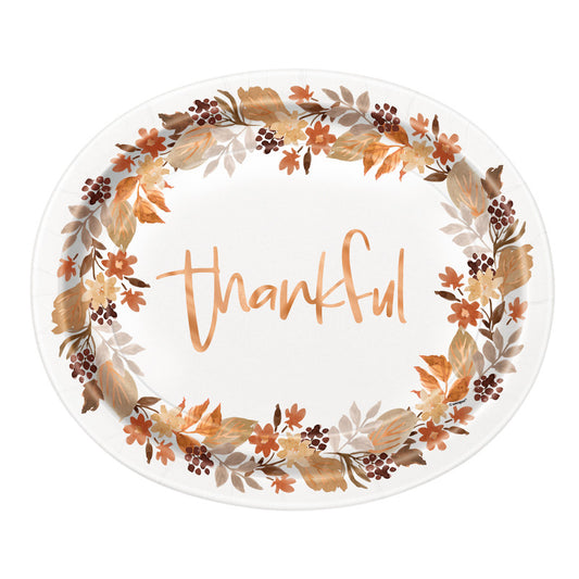 Oval white plate with autumn leaves border in brown and orange hues and "thankful" written in cursive orange letters.