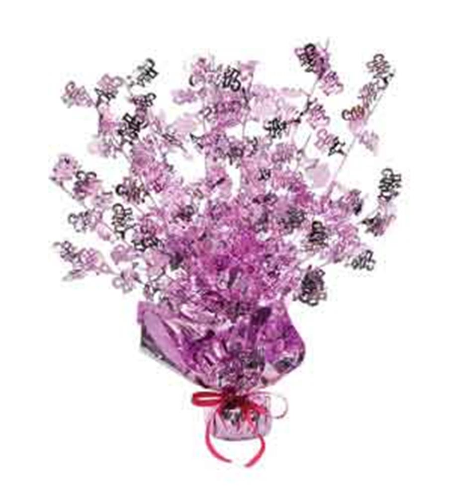 Pink foil centerpiece with "It's a Girl" confetti and star-shaped accents for baby shower table decor.