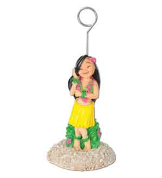 Colorful hula girl figurine with yellow skirt and green grass base holding a metal photo clip.