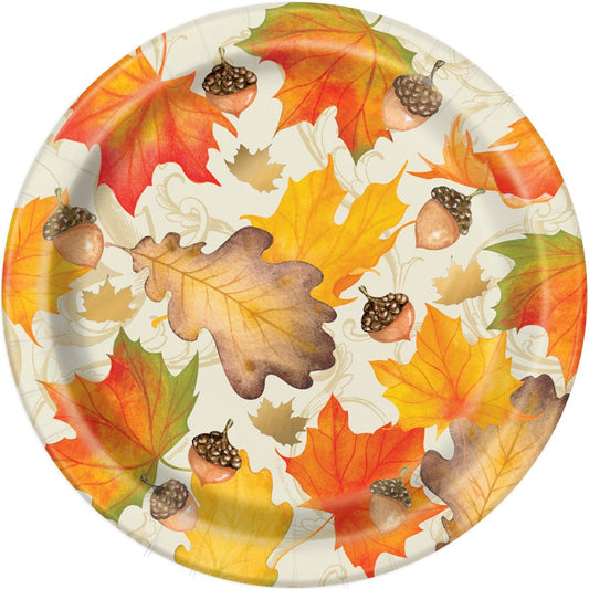 Round paper plate with colorful autumn leaves and gold foil acorn accents on a white background.