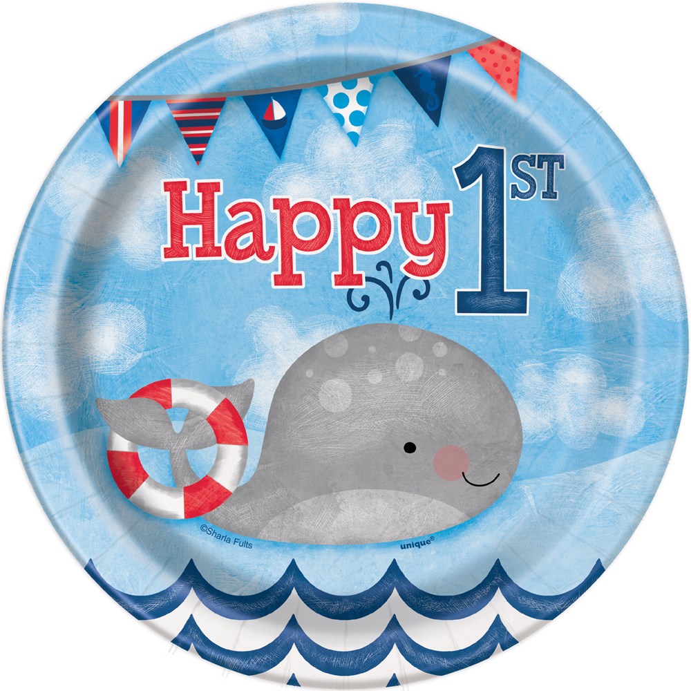 Round blue paper plate with a smiling gray whale, red and white lifebuoy, nautical pennant banners, and "Happy 1st" text for