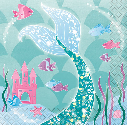 Square paper napkin with a glittery teal mermaid tail, pink castle, and colorful fish on a blue background.