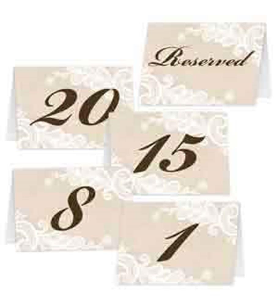 Beige folded wedding table cards with elegant black numbers and white floral lace detailing on corners, including a.