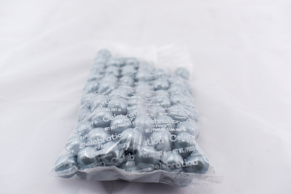 Clear plastic bag filled with glossy silver gumballs tightly packed inside.