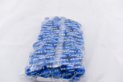 Clear plastic bag filled with bright blue round gumballs tightly packed inside.