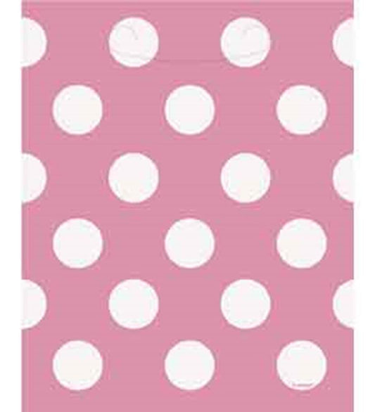 Hot pink rectangular bag with large white polka dots, smooth glossy finish.