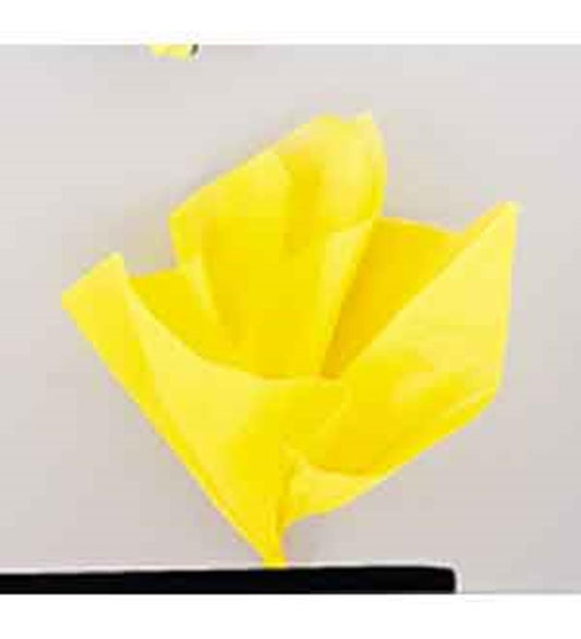 Bright yellow tissue paper sheet loosely folded on a flat surface.