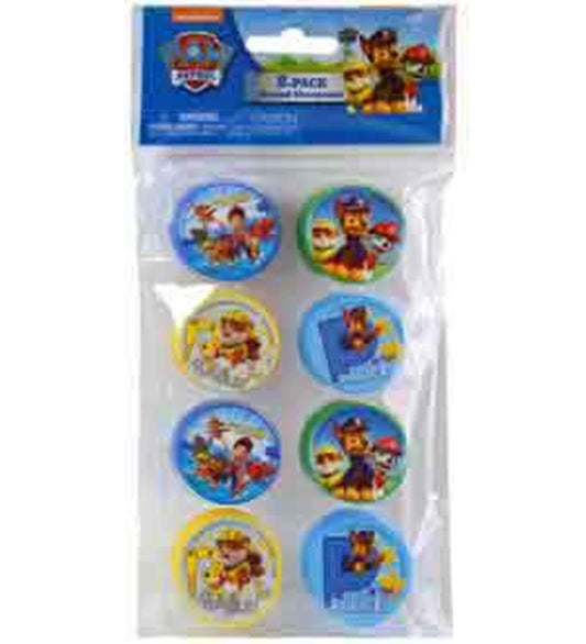 Set of eight round plastic pencil sharpeners featuring colorful Paw Patrol character designs on top in blue, yellow, and red