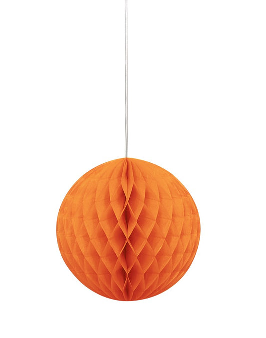 Pumpkin orange honeycomb paper ball with a 3D geometric honeycomb texture hanging by a string.
