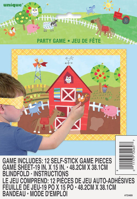 Colorful farm-themed party game board with barn, animals, and white fence; child placing brown piece on board.