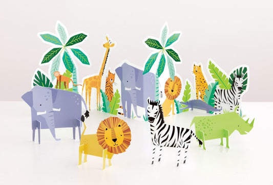 Five colorful cardboard safari animal table decorations including lion, zebra, elephant, giraffe, and hippopotamus with palm