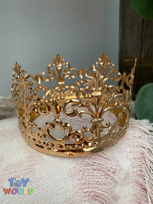 Gold metal crown with intricate filigree design and fleur-de-lis accents.