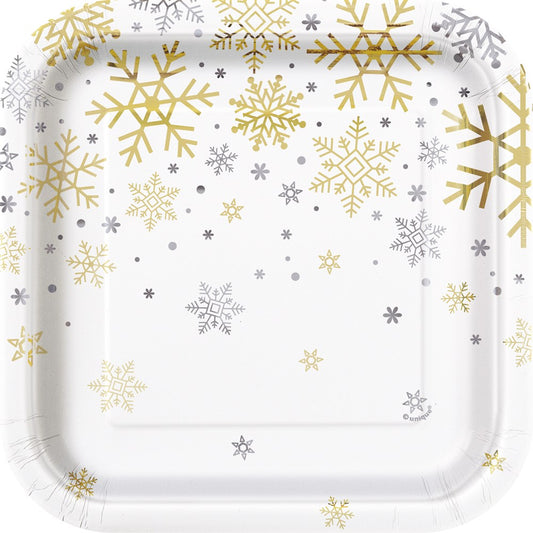 Square white paper plate with gold and silver snowflake patterns scattered on the surface.