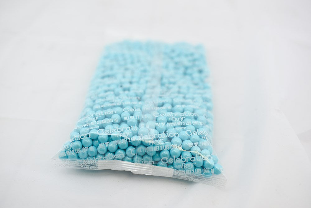 Clear plastic bag filled with small, round, powder blue pellets, 2-pound size.