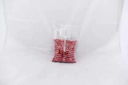 Clear plastic bag filled with small red pellets labeled SiXLets Red 2lb bag.