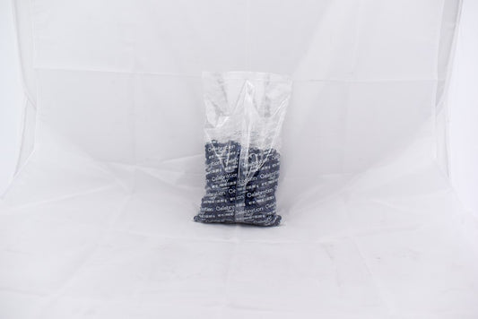 Clear plastic bag containing multiple navy blue SiXLets exercise balls stacked inside.