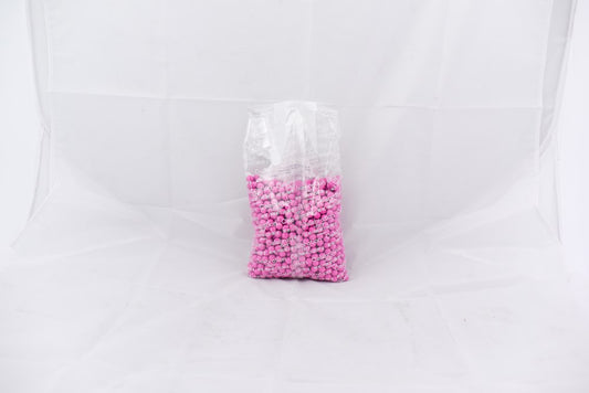 Clear plastic bag filled with bright hot pink small round pellets weighing 2 pounds.
