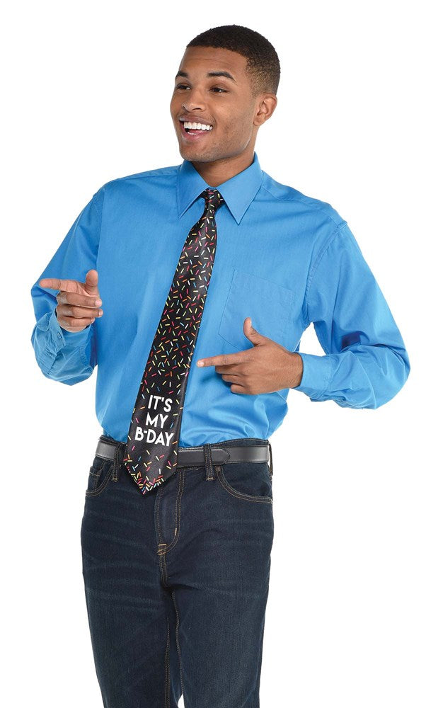 Black birthday tie with colorful confetti and "It's My Day!" text worn with blue shirt and jeans.