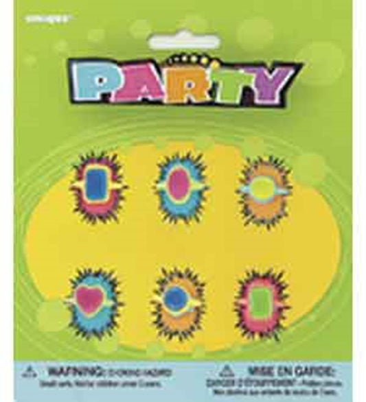 Set of six colorful plastic rings with flower-shaped bases and oval centers in blue, pink, and green on a yellow card.