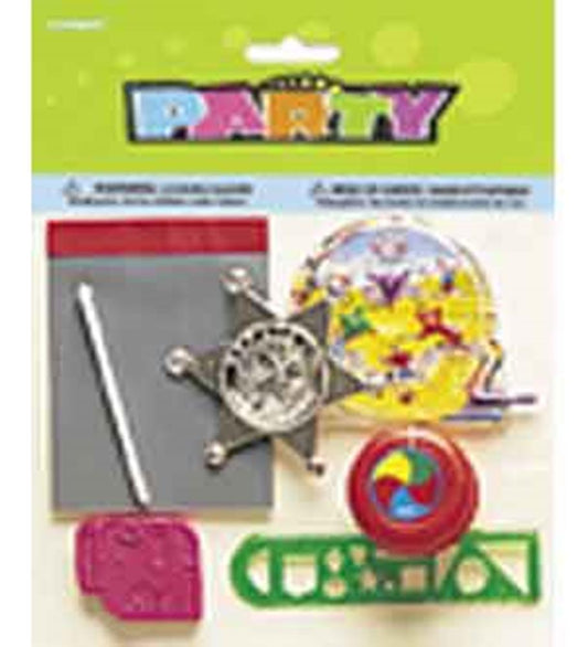 Assorted boys party favors including a silver sheriff badge, colorful spinning top, green plastic whistle, multicolored.