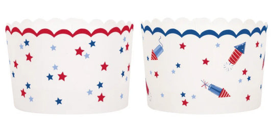 White scalloped paper treat cups with red and blue star patterns and red scalloped trim on one, blue scalloped trim and.