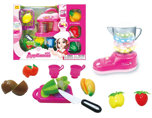 Pink plastic toy blender with colorful translucent pitcher, toy vegetables, fruits, play knife, and cutting board set.