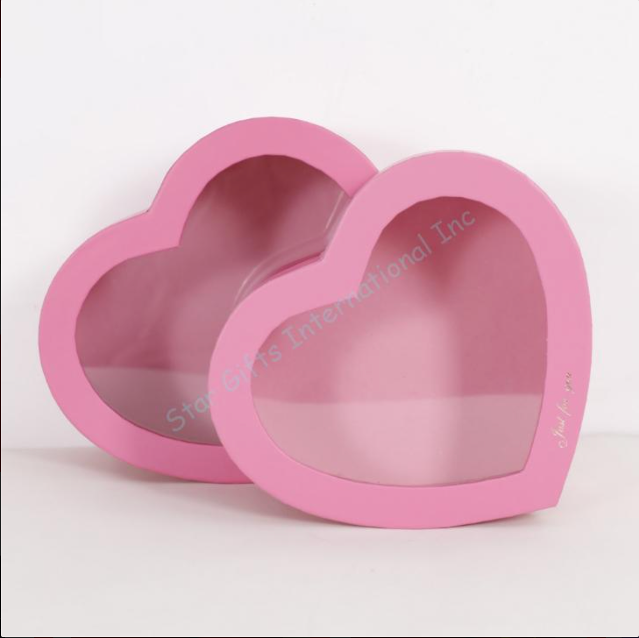 Two pink heart-shaped gift boxes with transparent lids, one 10-inch and one 11-inch, made of sturdy cardboard.