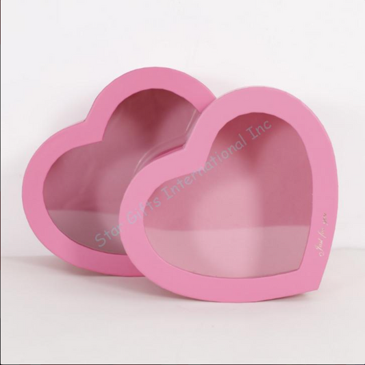 Two pink heart-shaped gift boxes with transparent lids, one 10-inch and one 11-inch, made of sturdy cardboard.