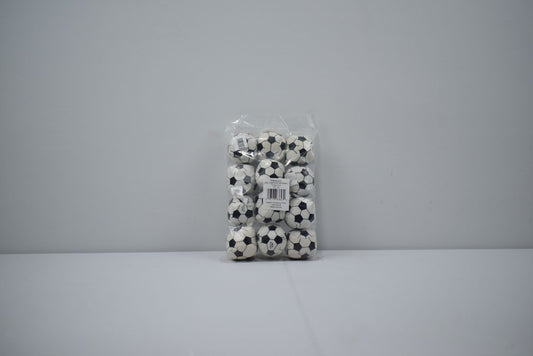 Clear plastic bag containing 12 small black and white classic soccer balls against gray background.