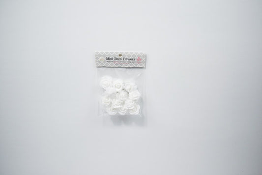Package of 12 small white foam flowers with layered petals, 1 3/4 inches wide, for party decoration.