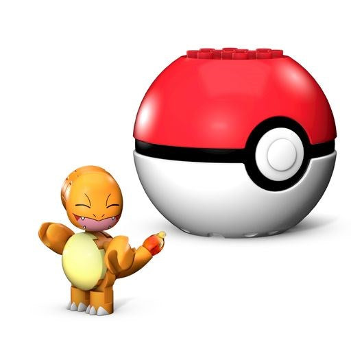 Small orange and cream block-built Charmander figurine with flame tail next to red and white Poké Ball toy block container.