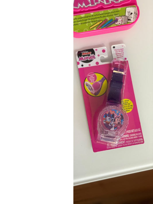 Pink and purple Disney Minnie Mouse lip gloss watch with adjustable strap on bright pink blister card packaging.