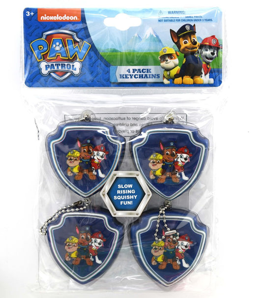 Set of four Paw Patrol shield-shaped squishy keychains featuring colorful dog characters on a blue background.