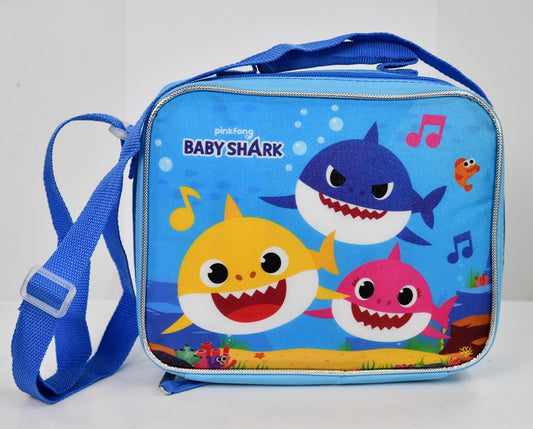 Blue rectangular lunch bag featuring smiling Baby Shark characters and colorful musical notes with an adjustable shoulder.