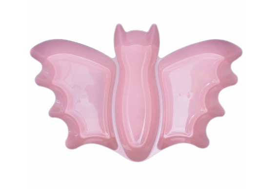 Pastel pink ceramic platter shaped like a bat with defined wings and bat ears.