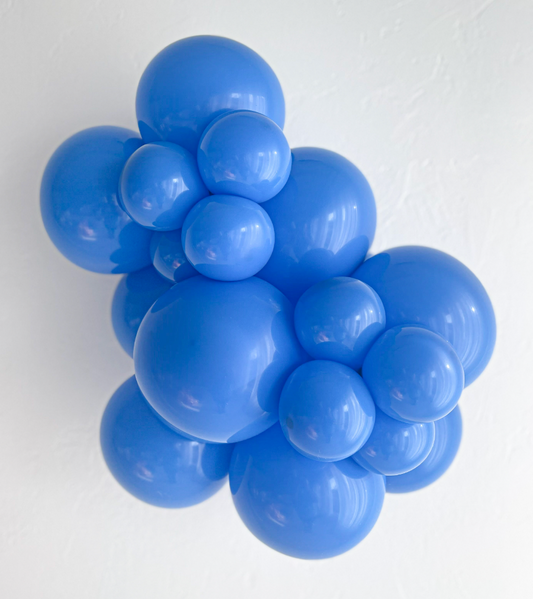 Cluster of shiny blue latex balloons in various sizes forming a decorative arrangement.