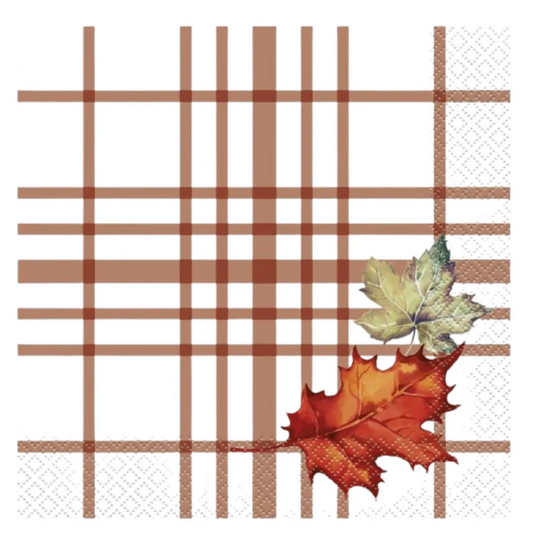 White lunch napkin with brown plaid lines and printed orange and green autumn leaves in corner.