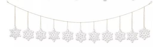 White wooden snowflake garland with ten intricately cut snowflakes hanging on natural twine string.